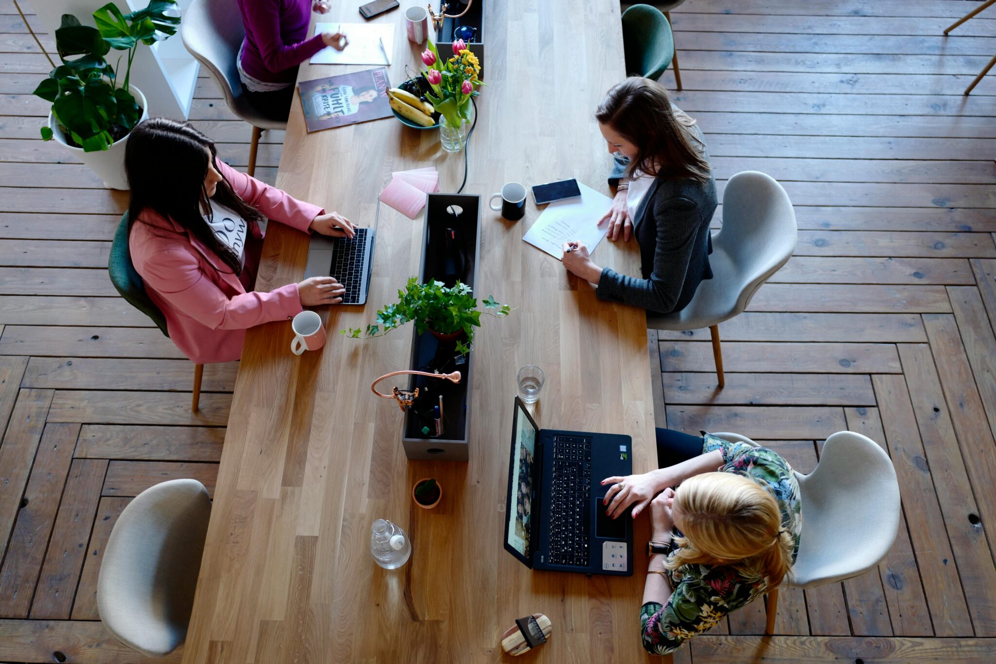 a group of people sitting across the tables, signifying leading teams via strength based leadership