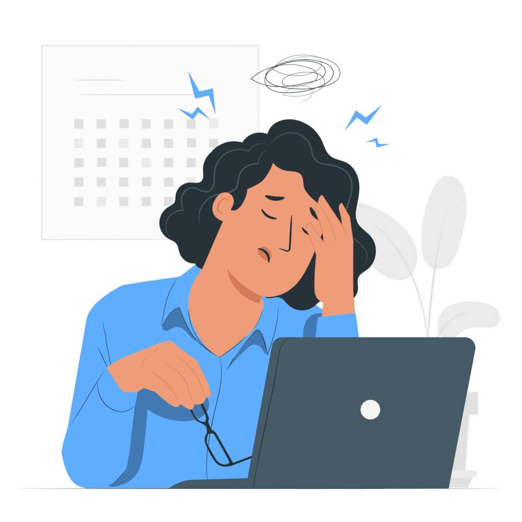 An image of a woman at her desk with a laptop, showing signs of stress and burnout.