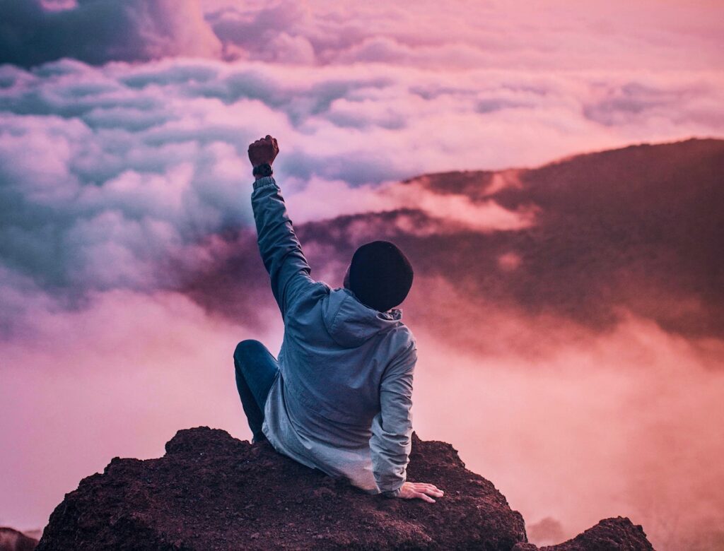 A man living his full life in fulfillment in the pink skies and having fun, showing that he learnt to re-imagine his life