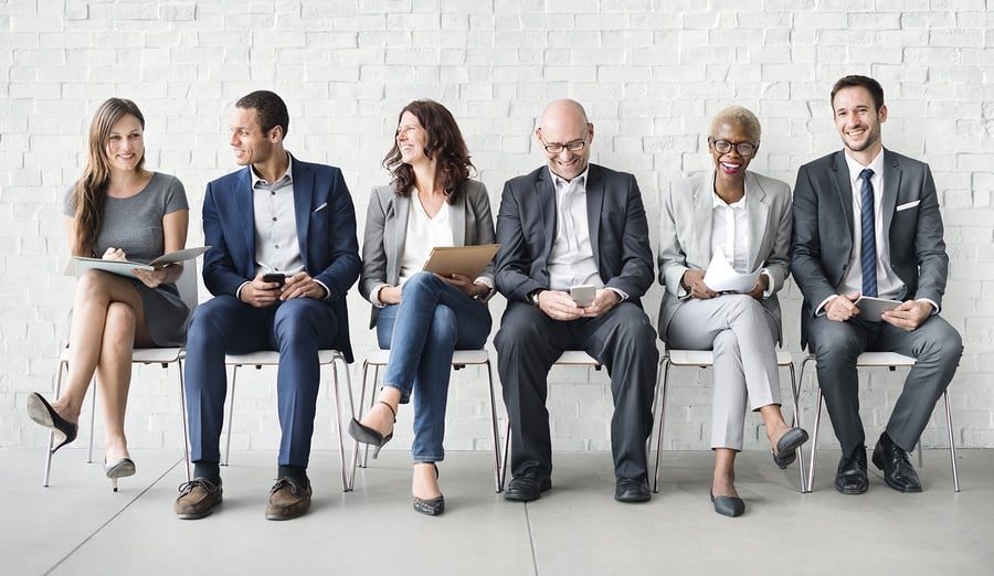 A group of diverse individuals with different age ranges working together in a collaborative and inclusive environment. Each person is engaged in their respective tasks, but there is an evident mutual respect and appreciation for each other's perspectives. The workspace is modern and technologically advanced but still accommodates varying work styles and preferences. There is an overall sense of harmony and productivity in the workplace.
