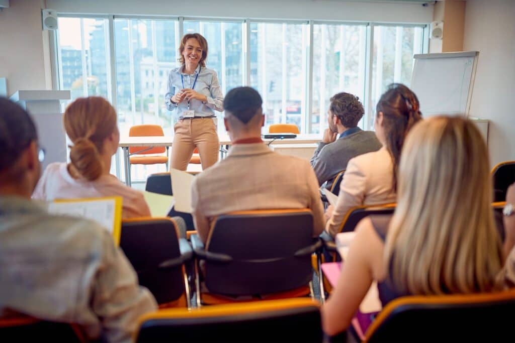 A woman giving a speech on the power and benefits of Strengths Workshop